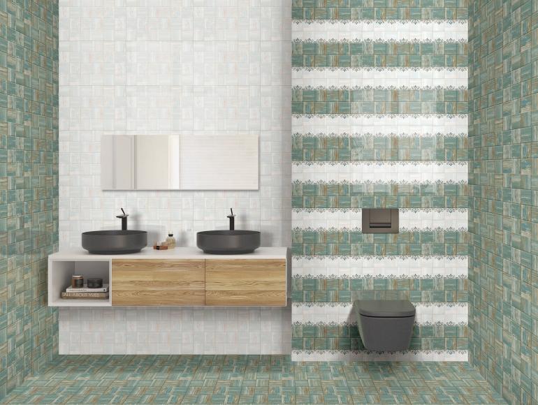 Elegant green bathroom design with patterned tiles, floating vanity, dual basins, and modern wall-mounted toilet.